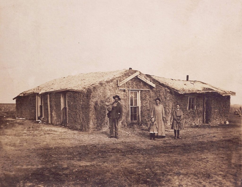 Madge at thirteen standing in front of her family’s sod house in Kansas, early 1900s. From Sod house to cloche
