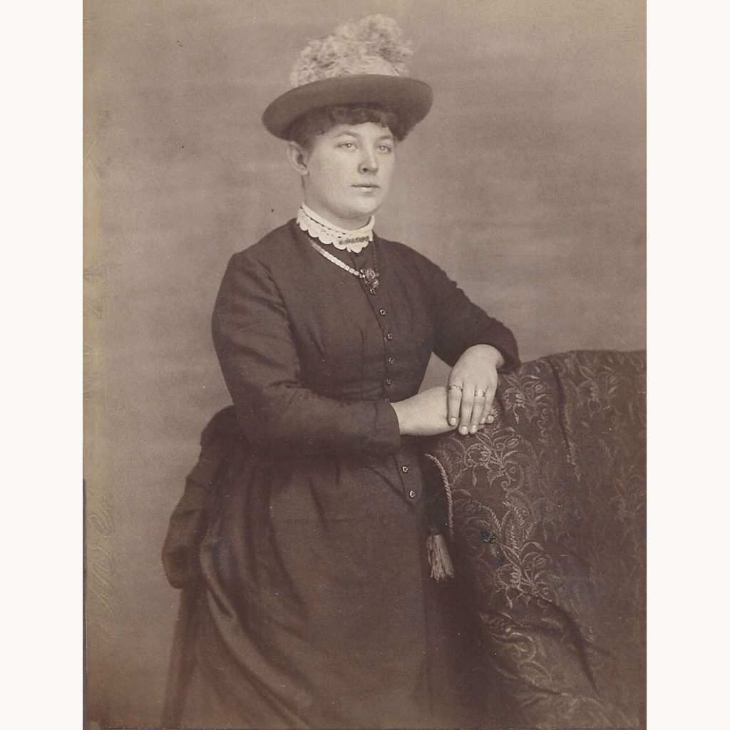 Portrait of Cousin Nannie Swindell wearing a late Victorian to early Edwardian hat and high-collared dress.