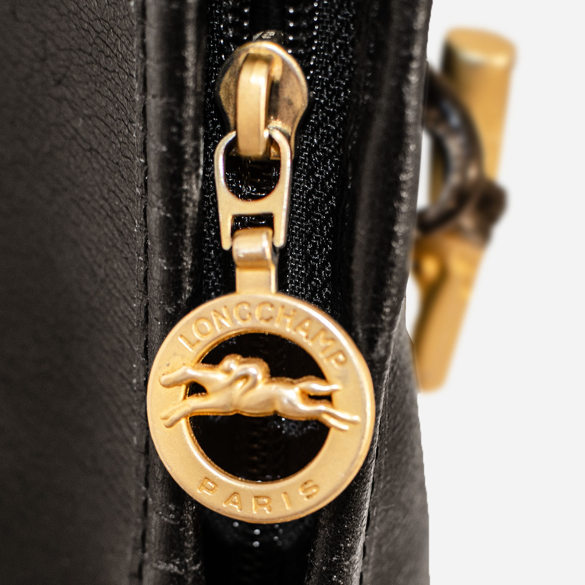 Longchamp metal logo tag zipper pull