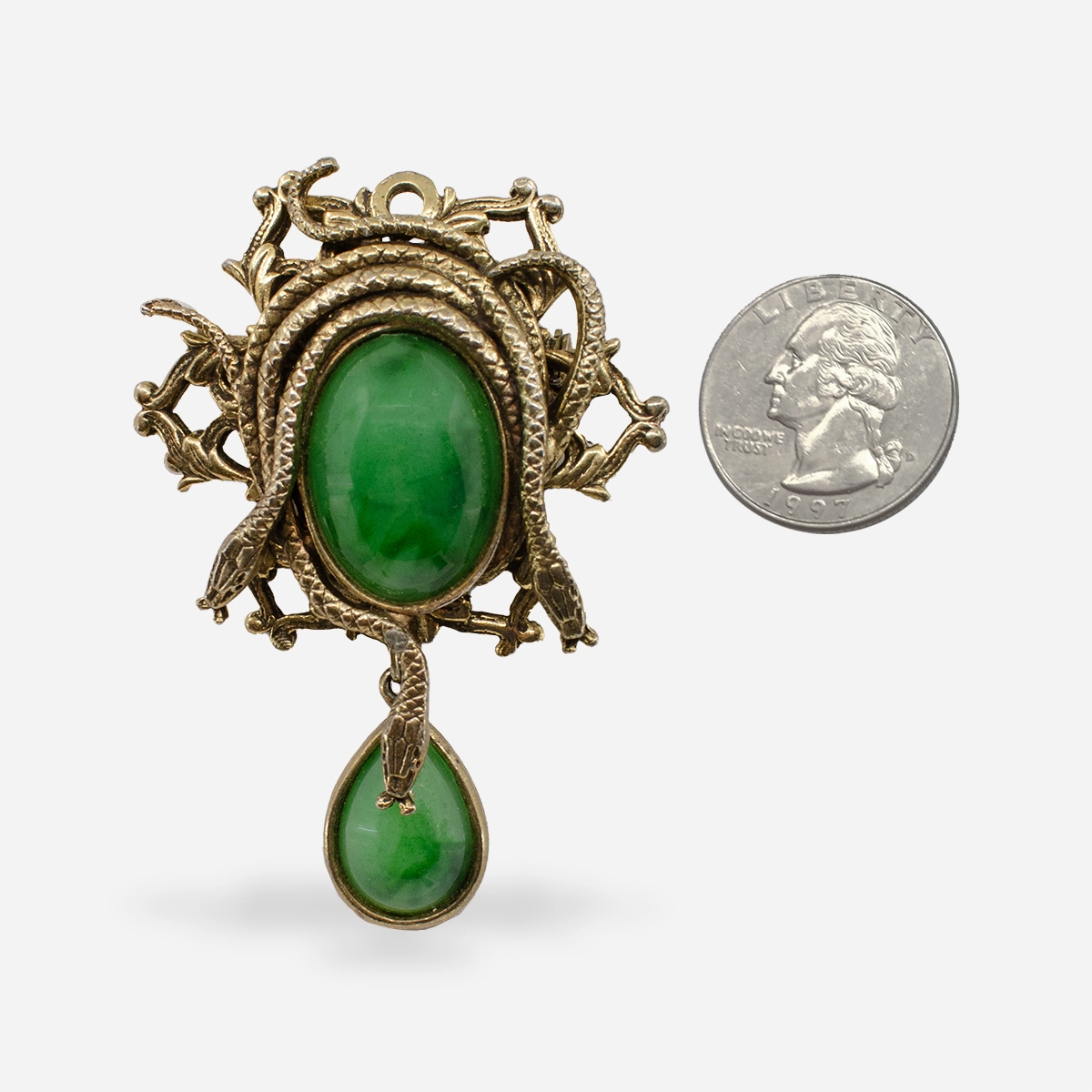 vintage green snake pendant with quarter for size