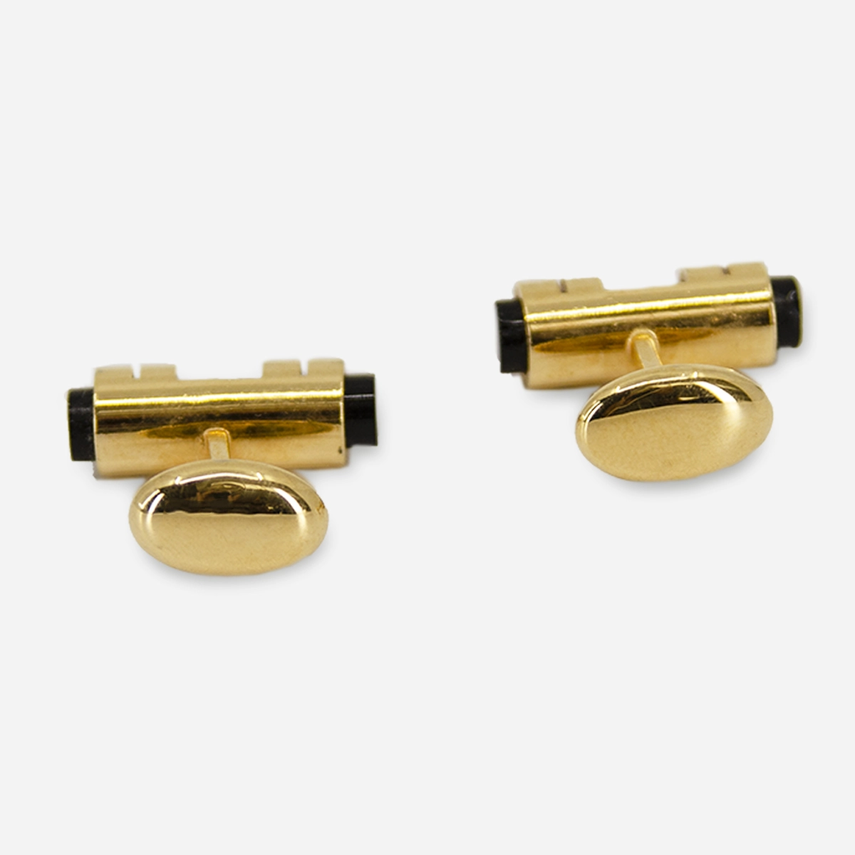 1970s onyx and gold-tone cufflinks with a bold barrel design and fixed oval backs. A sleek finish for tuxes or French cuffs.