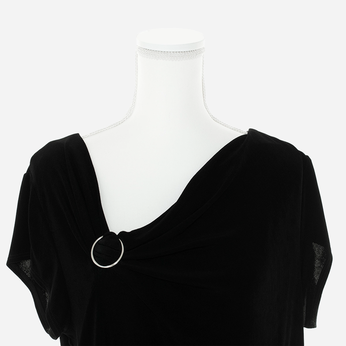 Close-up of asymmetrical neckline with silver ring detail on Chico’s Travelers black knit blouse