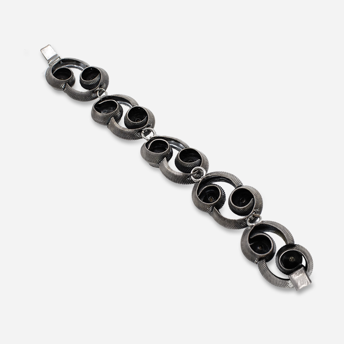 Back view of 1960s Napier silver-tone swirl link bracelet showing clasp and construction