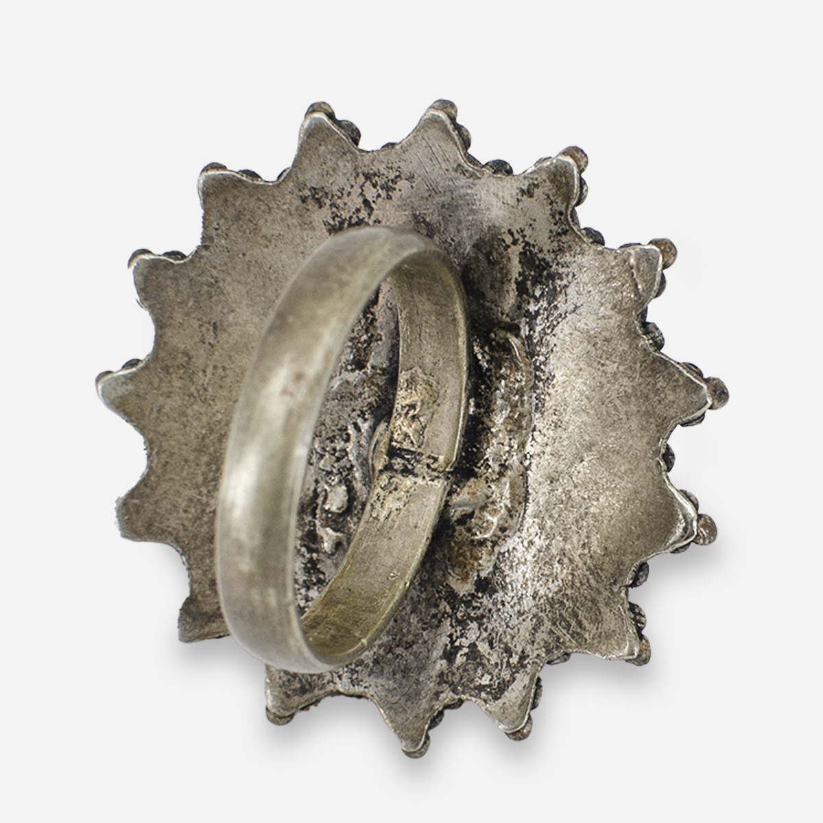 Back of silver-tone ring with large turquoise stone showing band and textured setting
