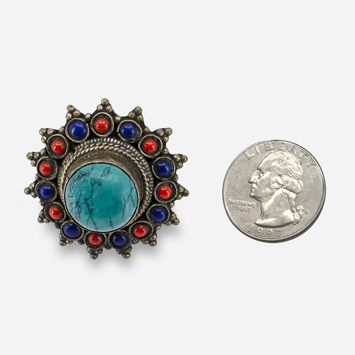 Angled view of large turquoise cabochon ring with colorful cabochon flower design