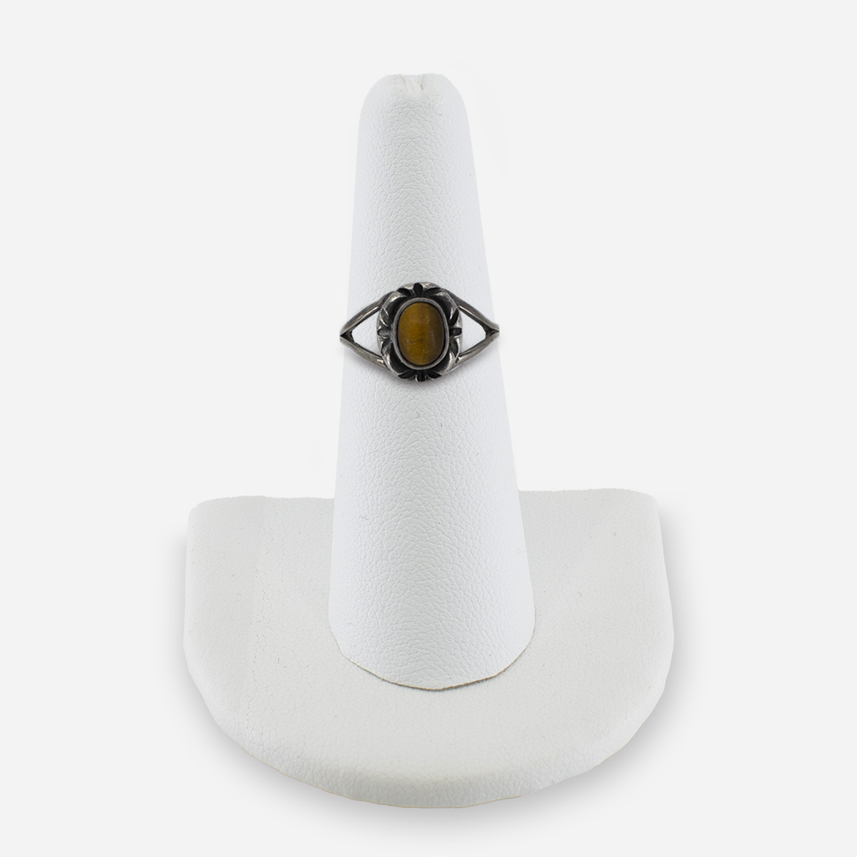 Sterling silver tiger’s eye ring, size 5.5, front view on display stand showing oval cabochon and starburst frame.