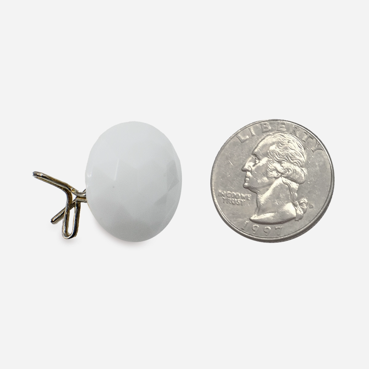 Vintage white glass wingback earring with gold clip and U.S. quarter for size reference.