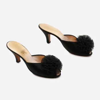 Side view of vintage Daniel Green high-heel mules in black satin.