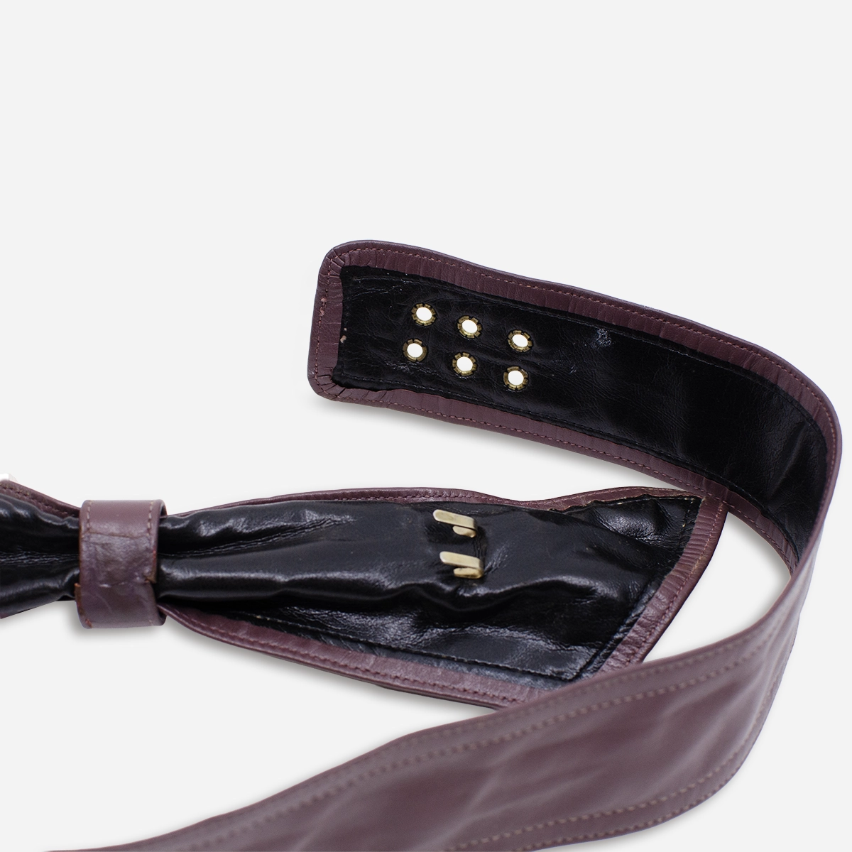 Close-up of interior hooks on vintage purple leather belt.