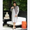 Model wearingg Steve Fabrikant 1990s gray knit dress on an outside deck