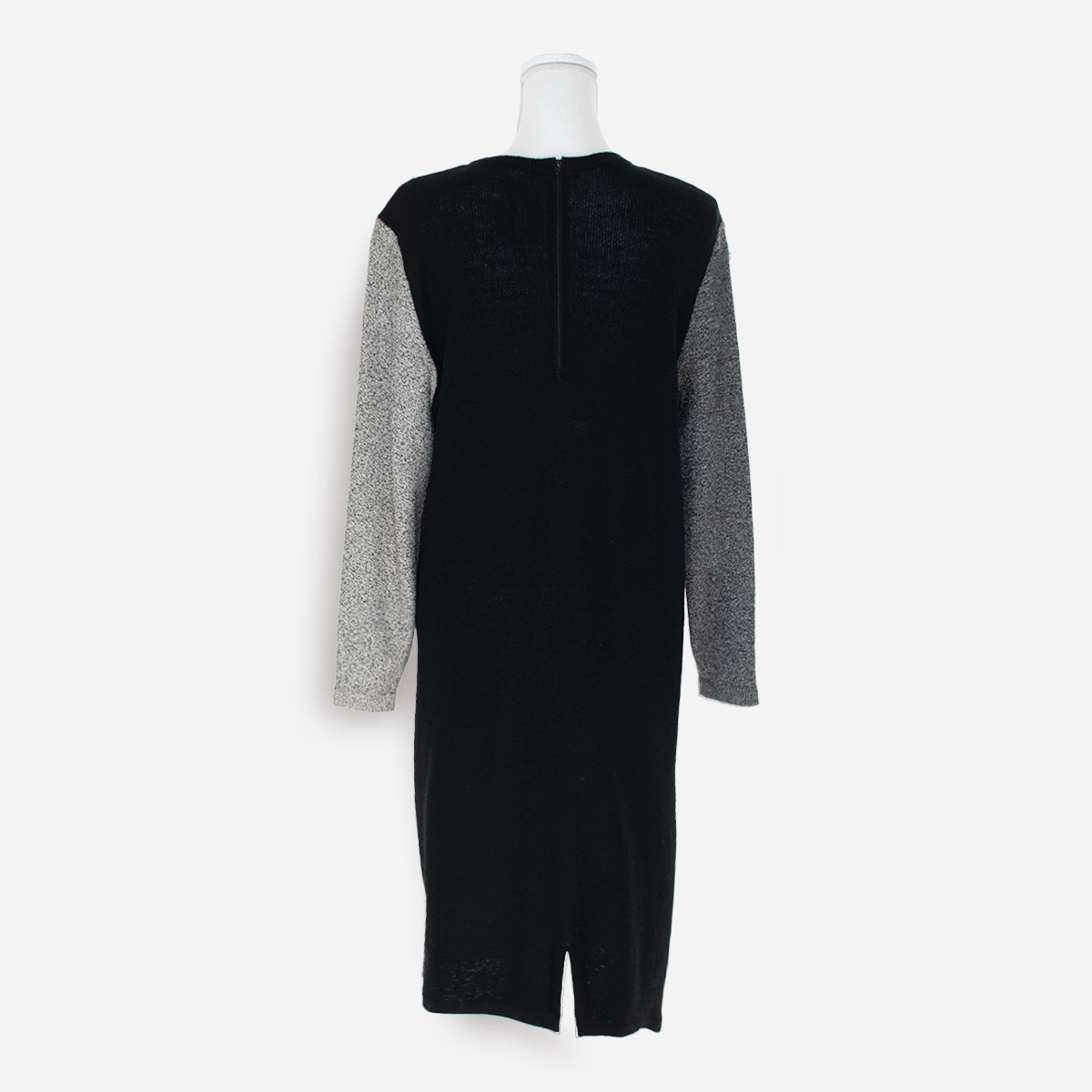 Back view: Solid black back of Fabrikant dress with back zipper and long sleeves.