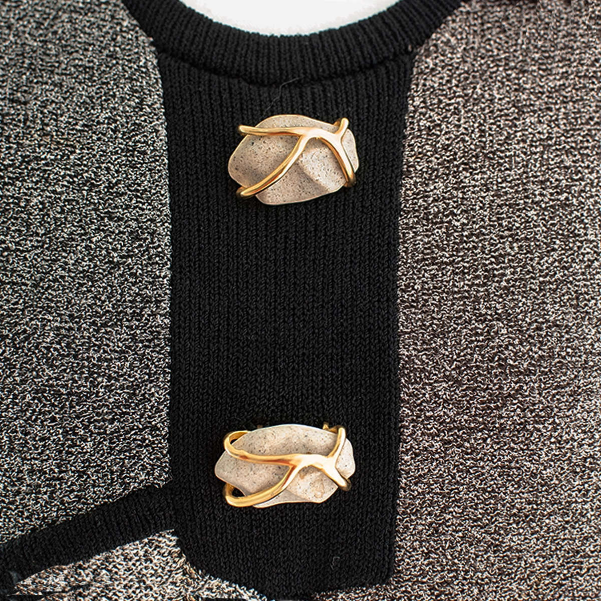 Detail shot: Close-up of faux-stone buttons with gold wrap detail on black trim.