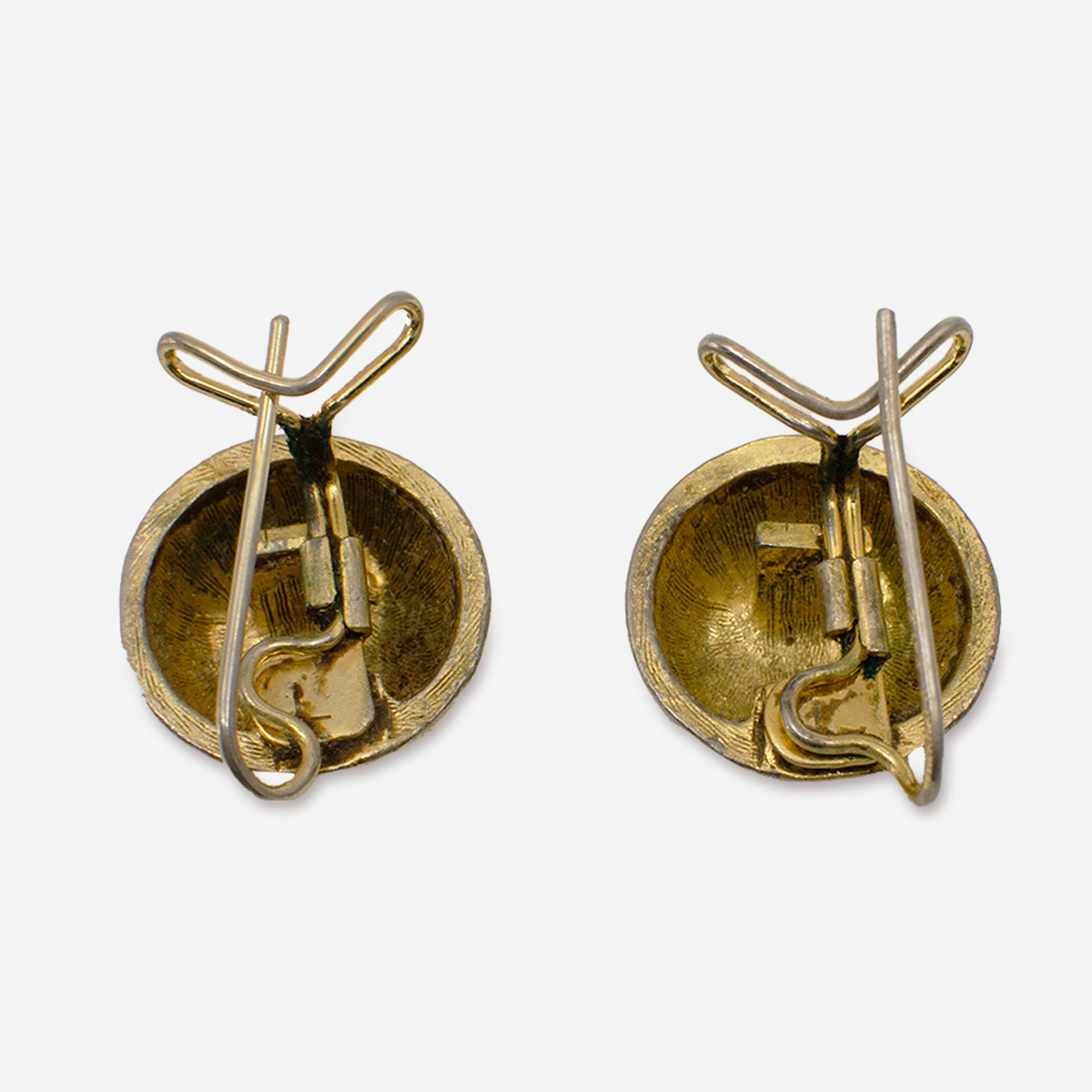 Interior of vintage gold-tone wingback earrings showing clip mechanism.