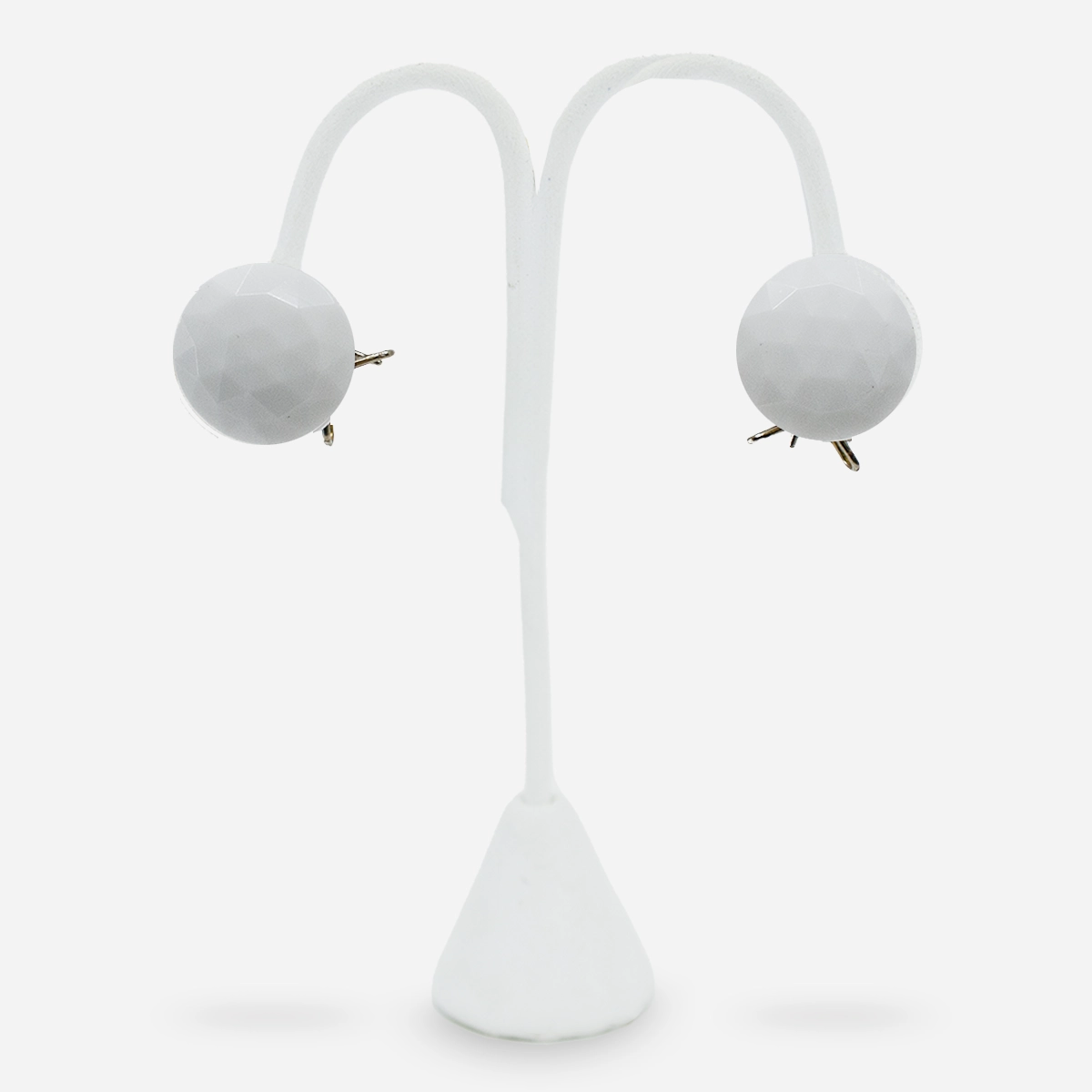 Vintage white glass button earrings on display stand.
