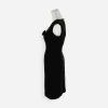 Side view left: “Side view of 1960s fitted black silk cocktail dress showing shapely silhouette.
