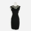 Front full view: “1960s fitted black cocktail dress with sexy illusion neckline and ribbon rosette by Marsi’s California.”
