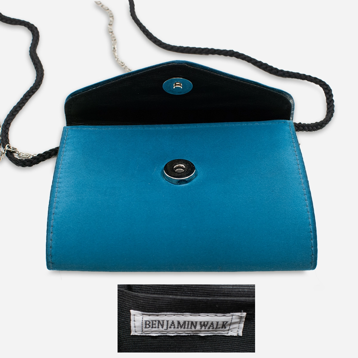 Interior view of blue Benjamin Walk bag showing snap closure and maker’s label.
