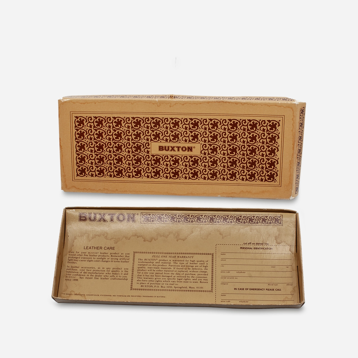 Vintage Buxton wallet box showing water damage and care instructions.