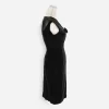 Front close-up: “Close-up of sheer illusion neckline and ribbon rosette on 1960s black cocktail dress.”