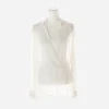 Front view of vintage Armani cream sheer silk blouse with deep wrap-style V neckline on mannequin. Front view of vintage Armani cream sheer silk blouse with deep wrap-style V neckline on mannequin.