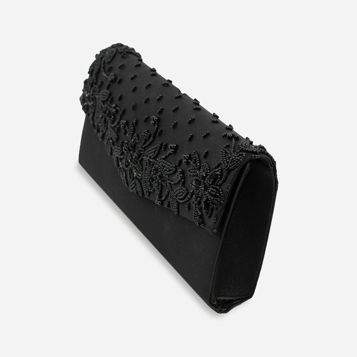 Side angled view of vintage black beaded clutch with rope strap.