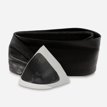 close-up of triangular silver and black buckle on vintage leather belt
