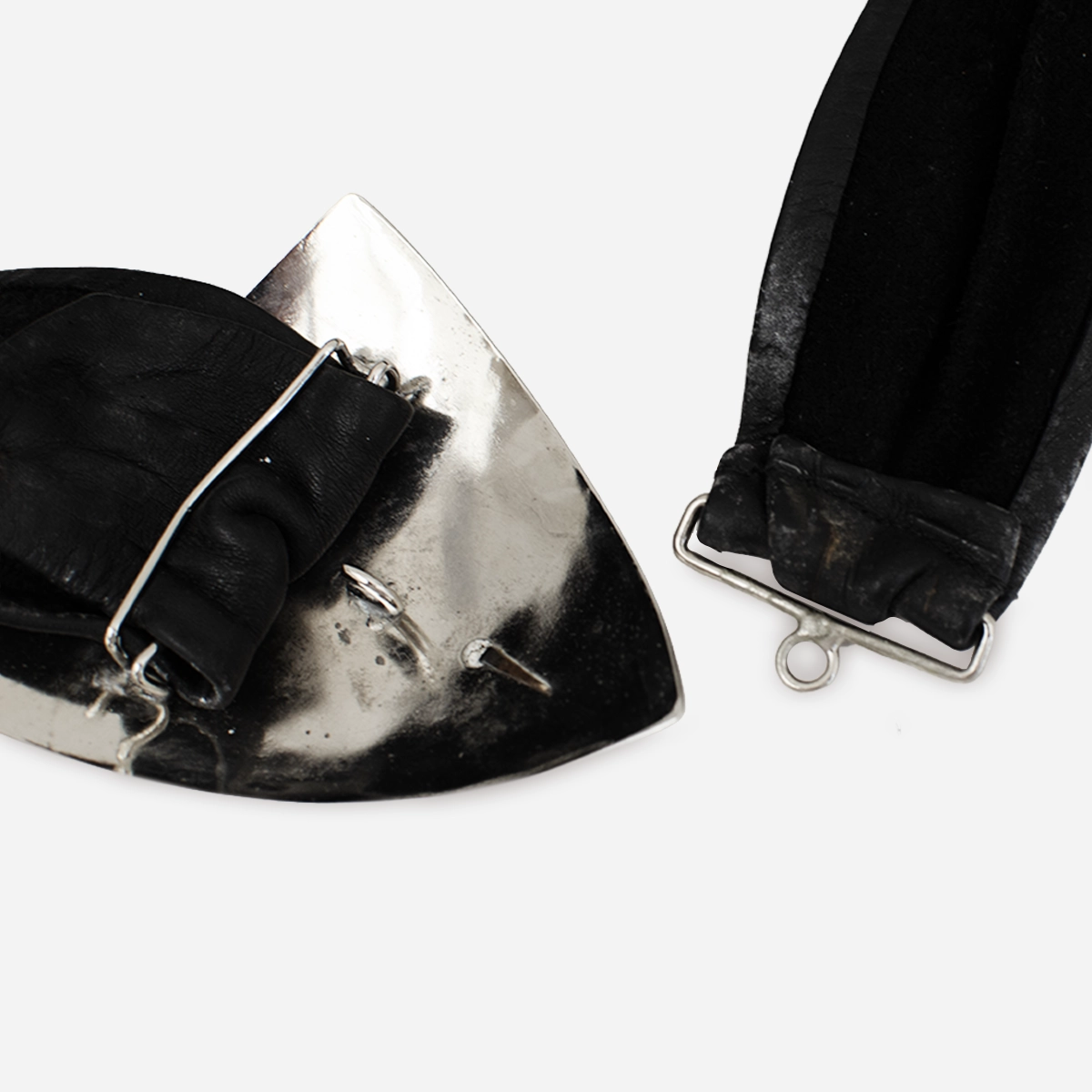 back view of silver metal buckle showing hook clasp and belt attachment