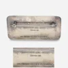 David Anderson – Nora Gulbrandsen brooch Back of David Andersen sterling silver brooch showing rock carving inscription. Close-up of D-A Norway Sterling 925S Nora Gulbrandsen hallmark on enamel brooch.