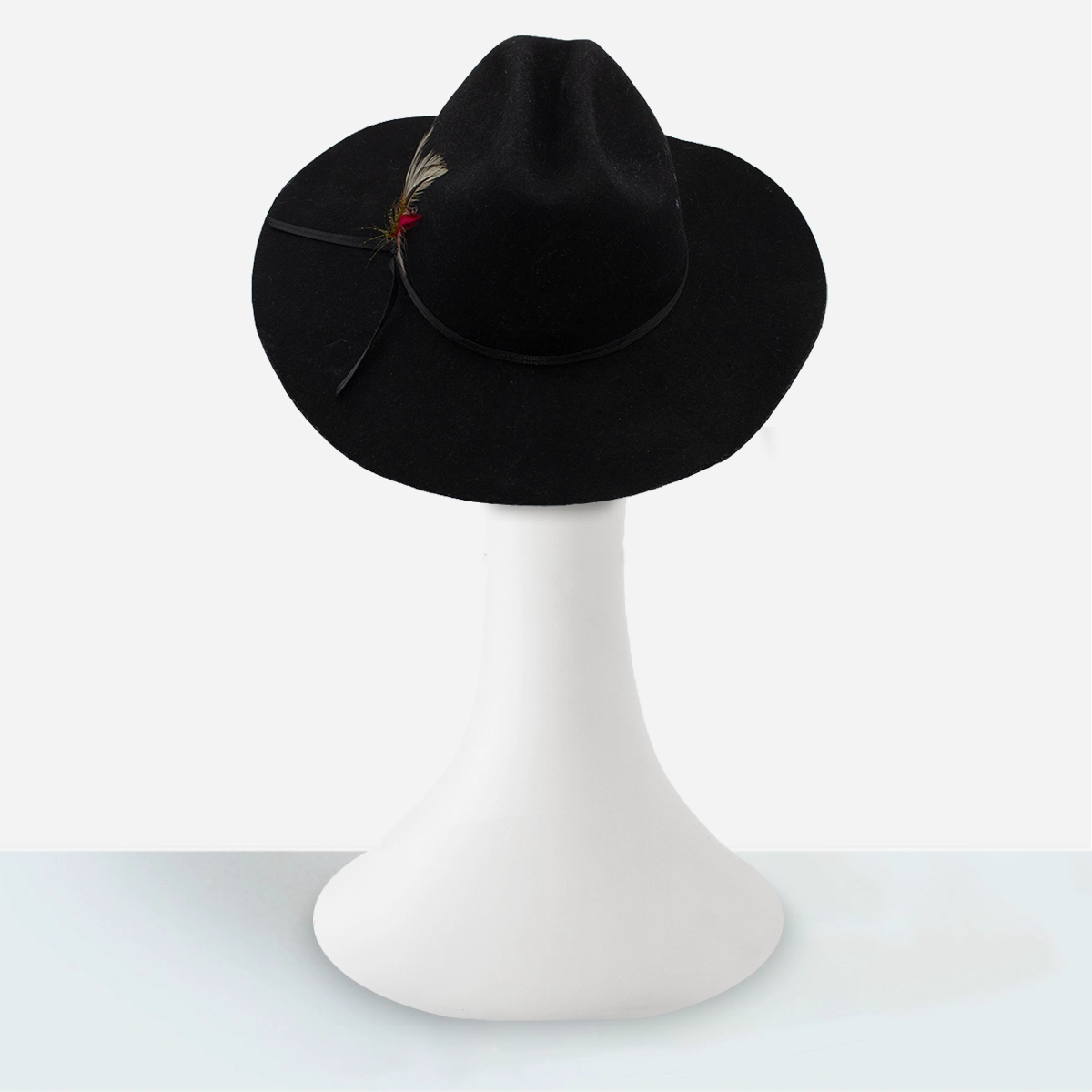 Back view of vintage black felt cowboy hat with ventilation grommets.