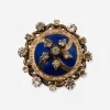 Antique blue enamel brooch with gold-tone die-stamped floral setting and paste stones.