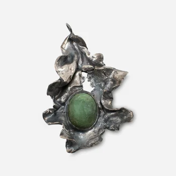 Close-up front view of the Brutalist silver pendant featuring a green jade cabochon set in free-form textured silver