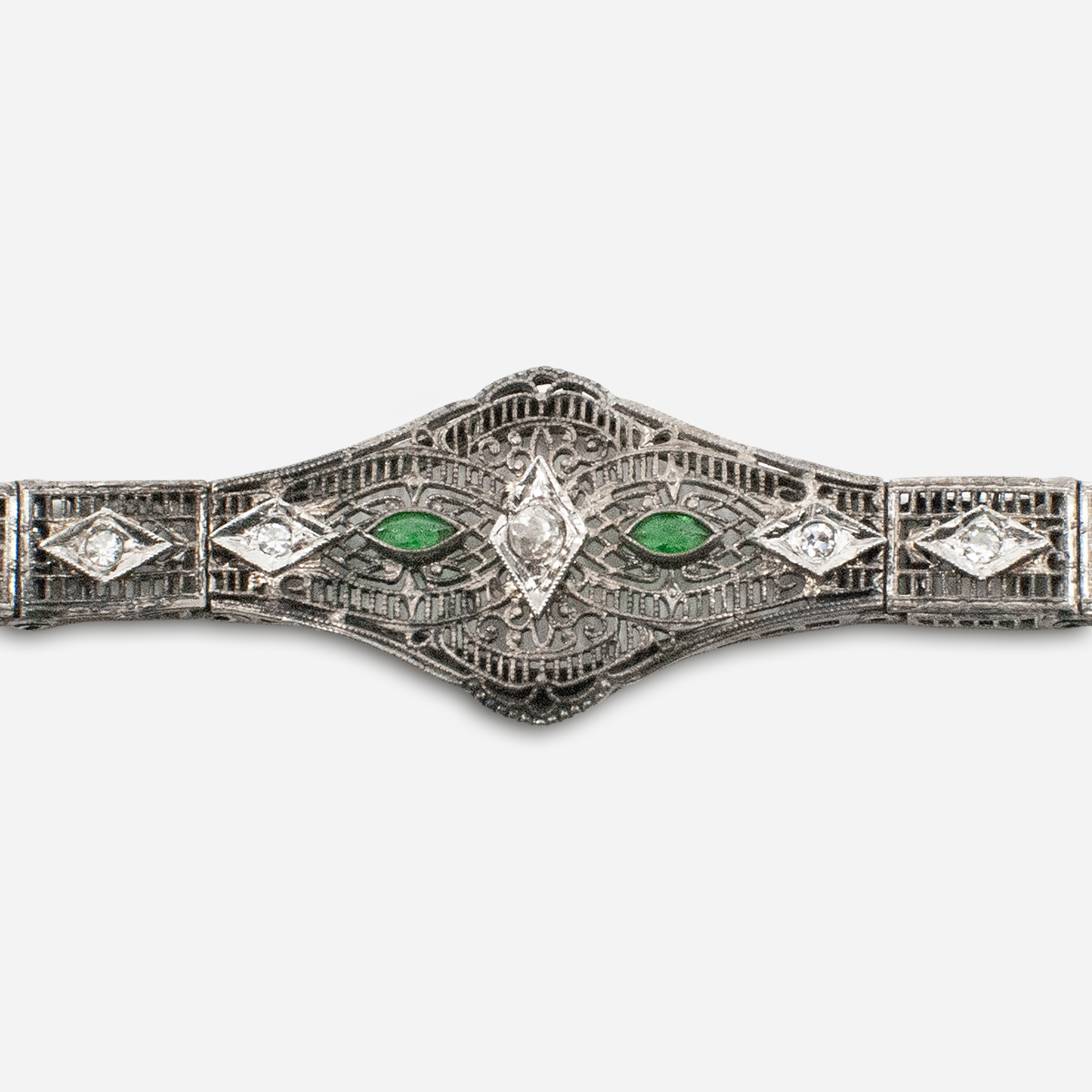 Close-up of emerald paste accents in Edwardian filigree bracelet