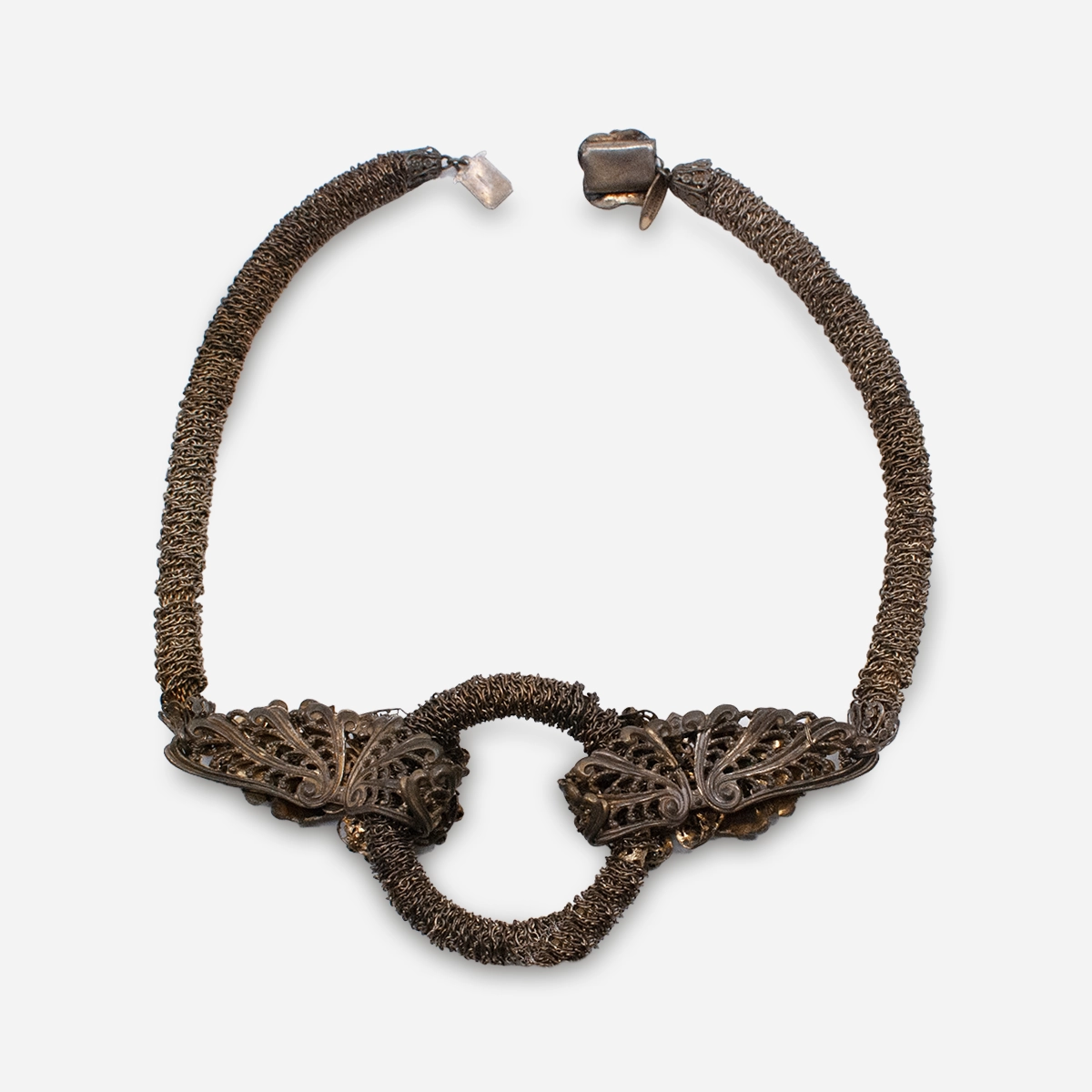 Vintage Miriam Haskell brass floral necklace laid flat showing open circular drop