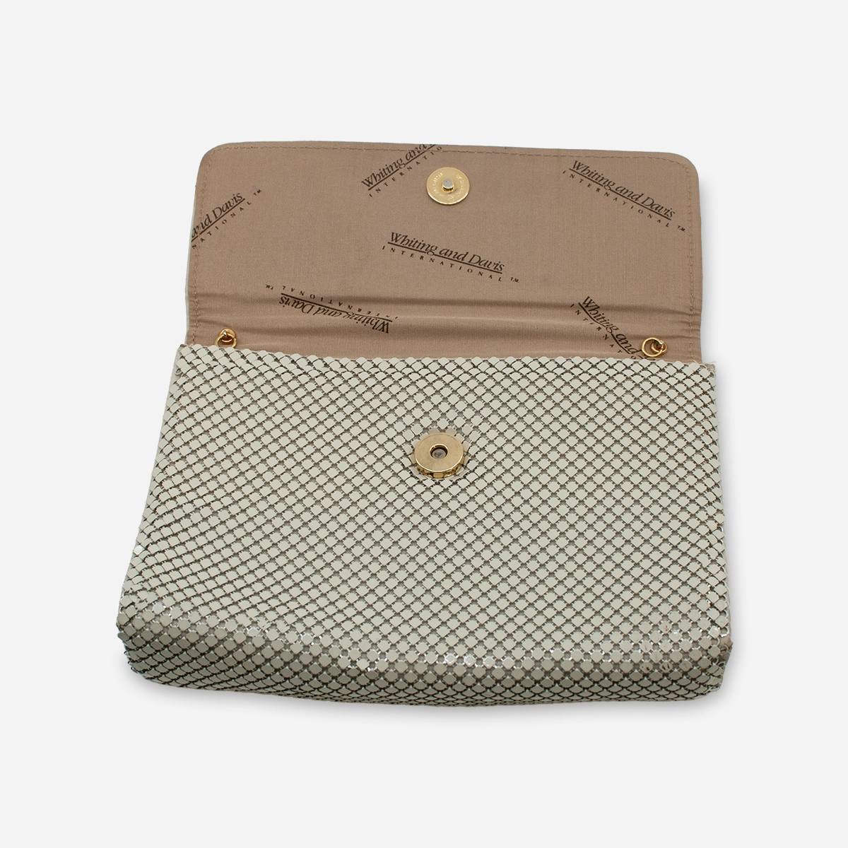 Interior of Whiting & Davis clutch with logo lining and gold metal rings