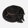 Vintage 1930s black straw tilt hat top view showing flat crown and bow