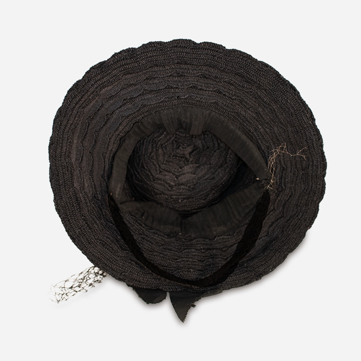 Interior view of vintage 1930s black straw percher hat showing crown shape.