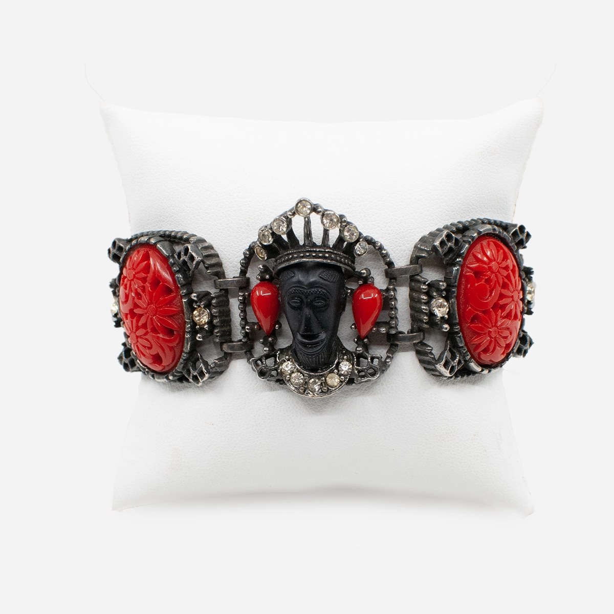 Close-up of Selini figural bracelet showing crowned resin heads and rhinestone accents.