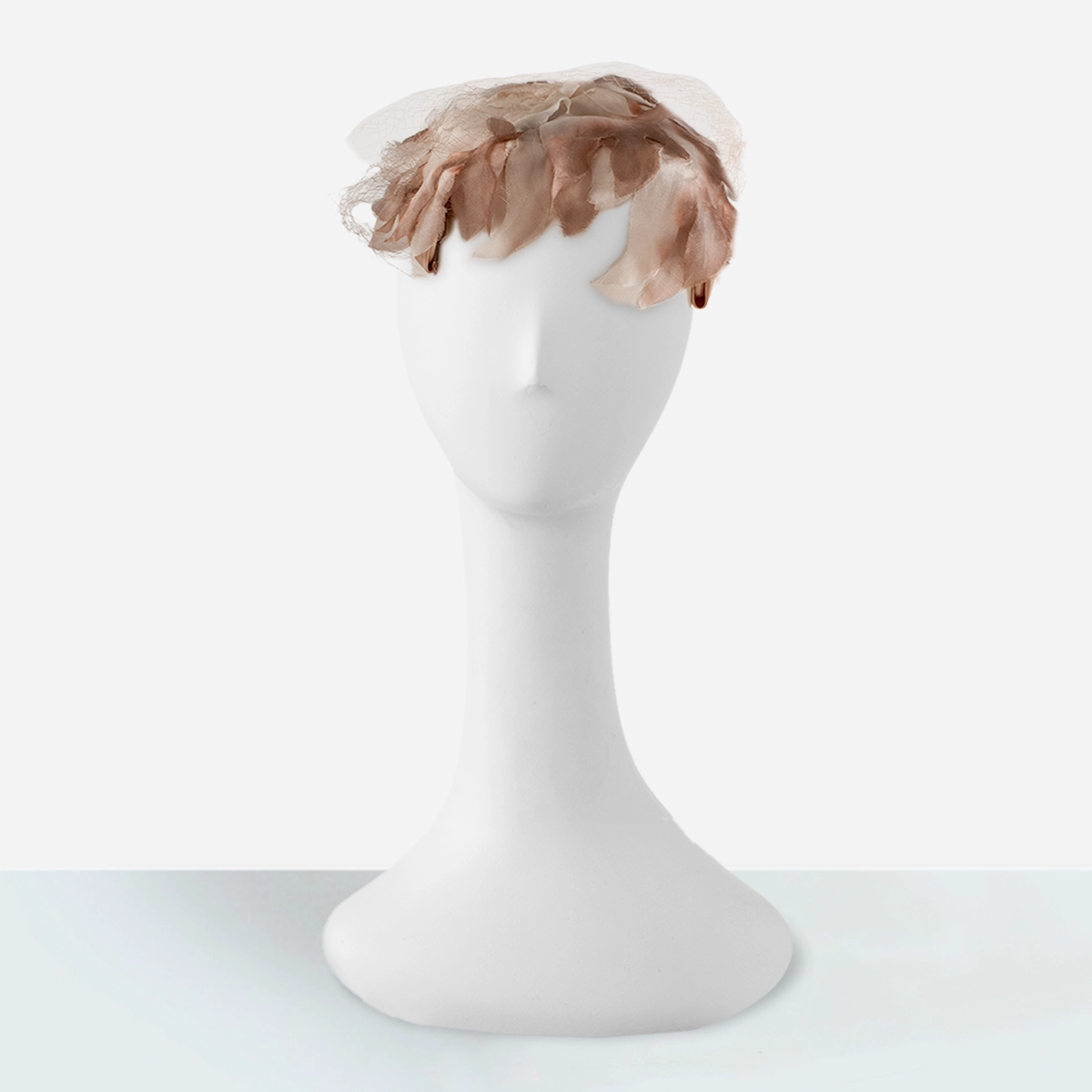 1950s dusty pink and cream silk flower petal close hat on mannequin.