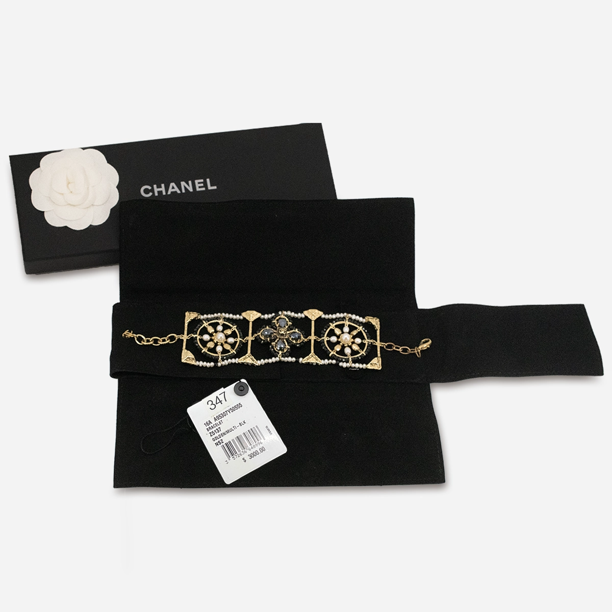 Vintage Chanel bracelet displayed with original box and felt pouch.