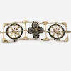 Faux pearl quatrefoil Chanel braceleet Close view of Chanel bracelet showing pearl edging and crystal quatrefoil.
