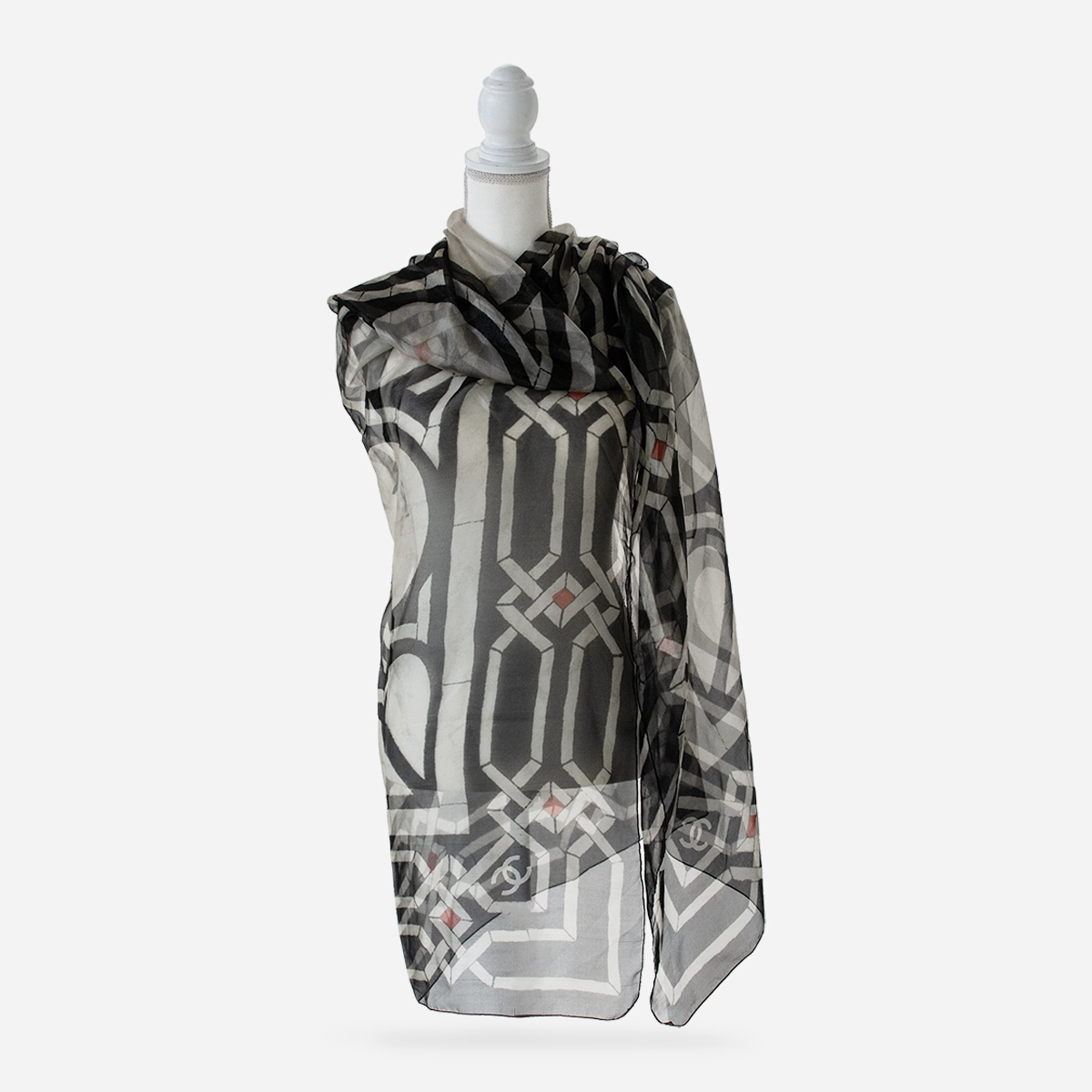 Chanel semi-sheer silk scarf draped on mannequin showing CC logo