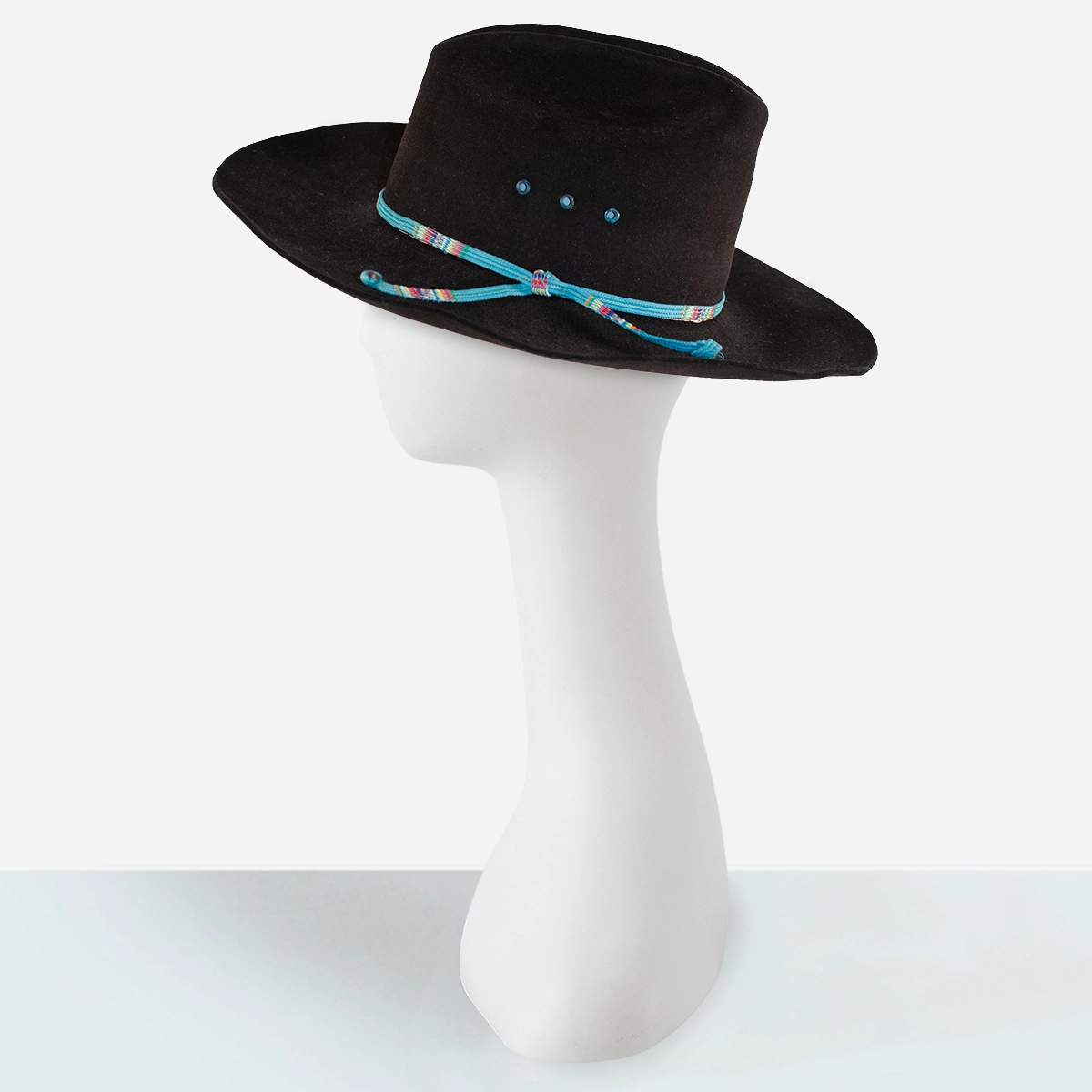 Mens black cowboy hat Side view of black Stetson cowboy hat showing cattleman’s crease and turquoise band.