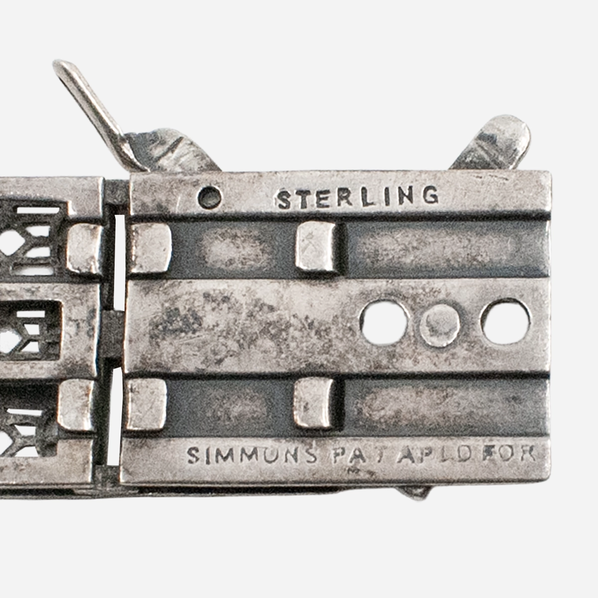 Simmons sterling bracelet hallmark with “Pat Applied For” stamp.