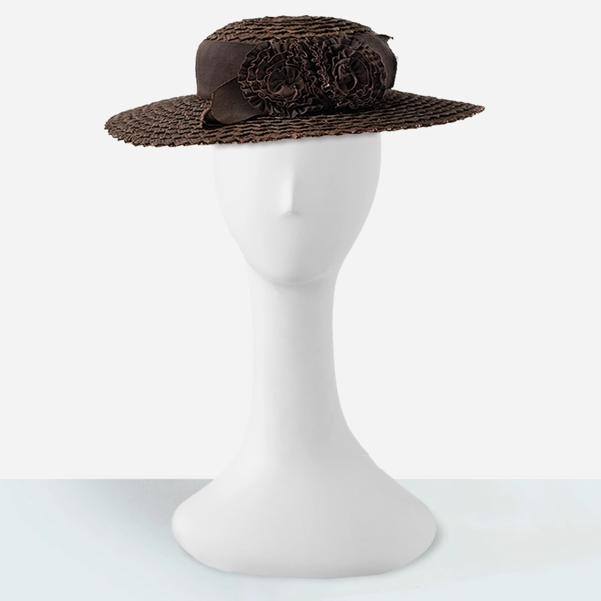Front view of 1930s brown wide-brim straw hat on display stand