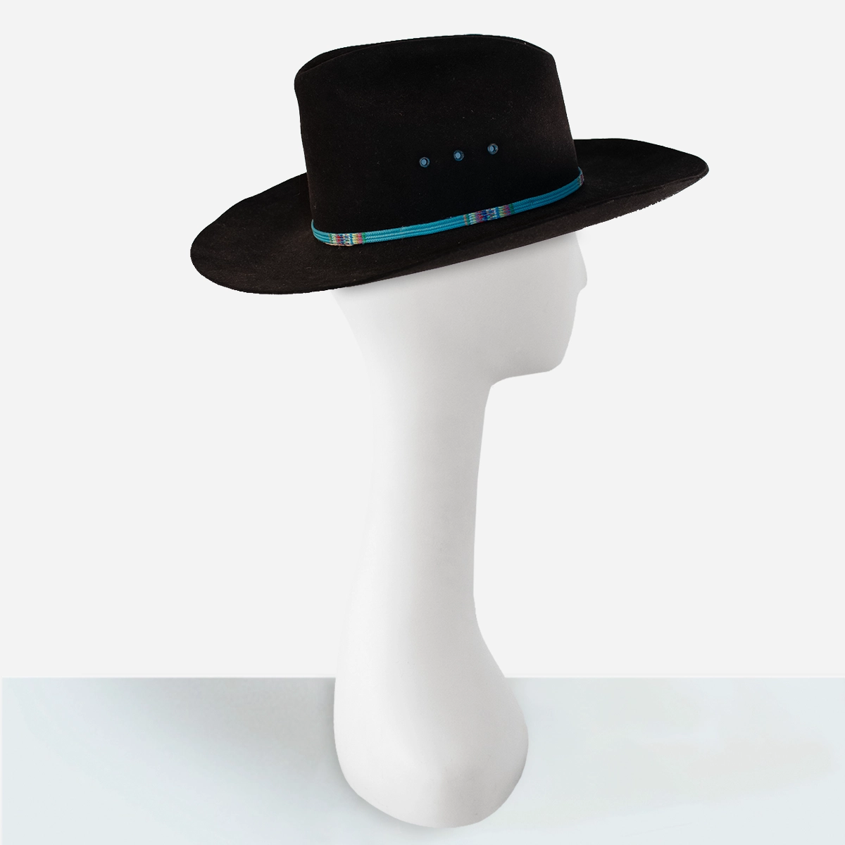 vintage black cowboy hat Angled view of vintage Stetson black cowboy hat highlighting turquoise band detail.
