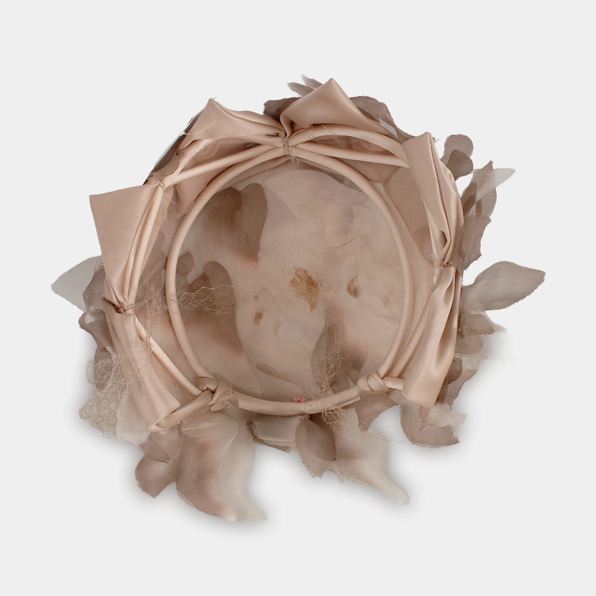 Interior view of 1950s close hat with satin-covered frame and triangle accents.