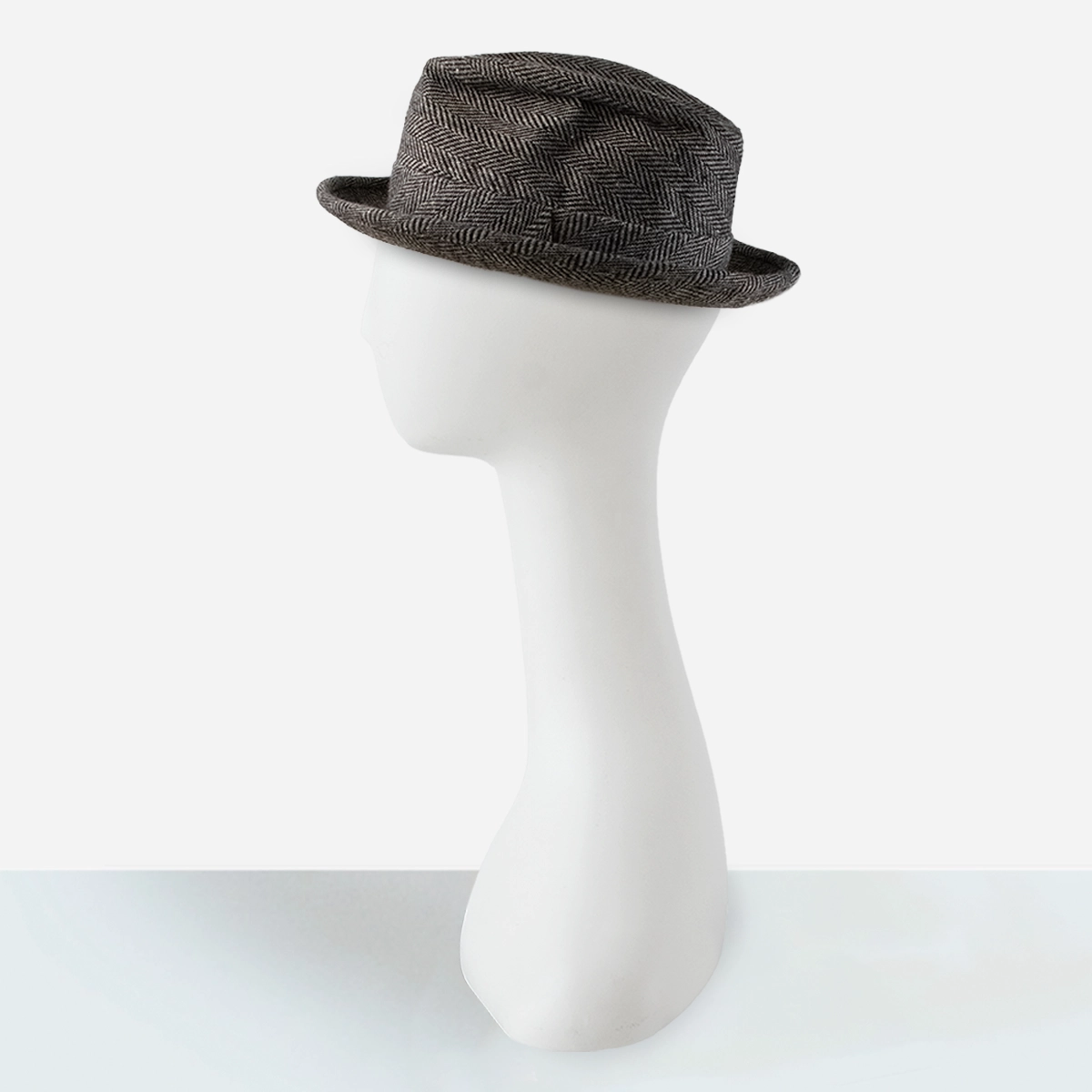 Side profile of vintage black trilby hat with snap brim