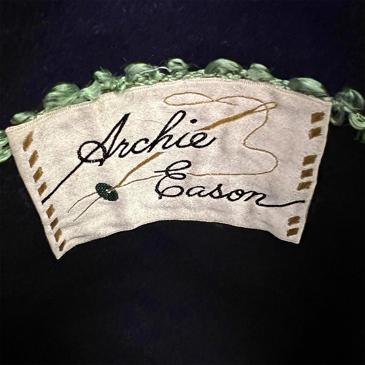 Archie Eason Green Sequin hat label