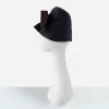 Side profile of 1950s draped cloche hat showing sculptural felt shaping