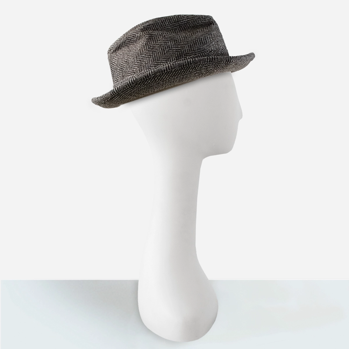 Angled view of 1970s black herringbone trilby hat with narrow brim